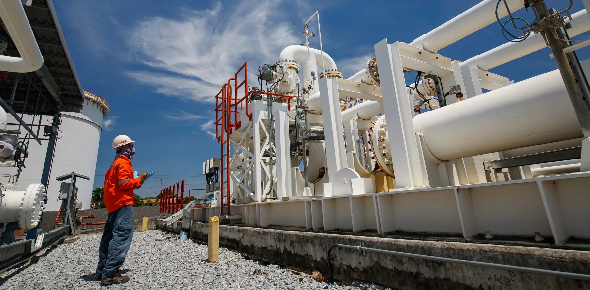 An operator recording an inspection at a process plant